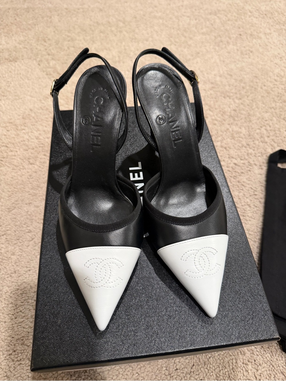 CHANEL Black and White Pointed Toe Slingback Pumps with Embossed CC